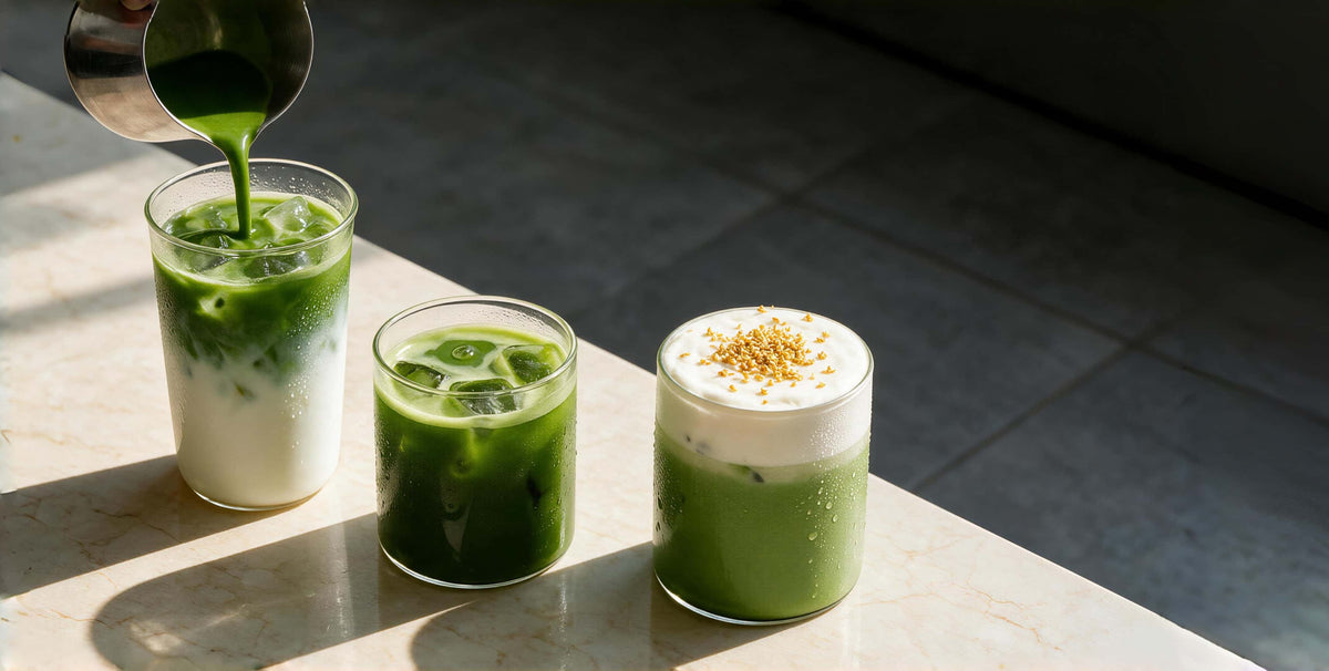 Three green iced drinks in clear glasses on a marble surface